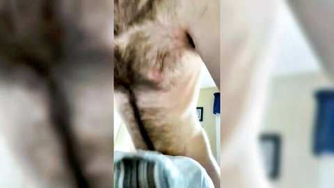 Blurry close-up of pale man moaning while humping pillow