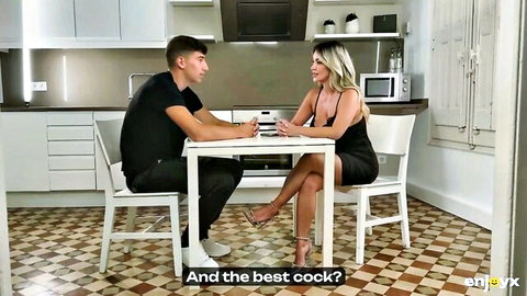 Blonde babe in tight black dress asks young stud about best cock at kitchen table