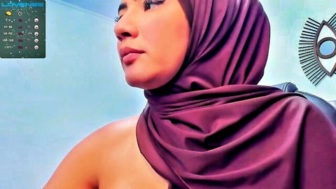 Sexy hijab woman in purple headscarf posing sideways showing bare shoulders and deep cleavage