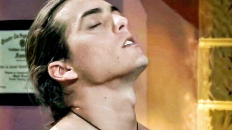 Long-haired brunette hunk moans in ecstasy with head tilted back during intense pleasure