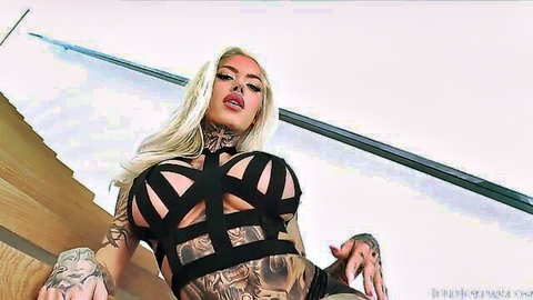 Chantal Danielle tattooed busty blonde in black harness lingerie exposing massive boobs