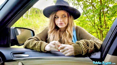 Blonde babe in black hat and open cardigan teases cleavage from public car pickup