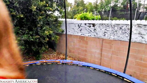 Busty redhead Ember Springs teasing on backyard trampoline