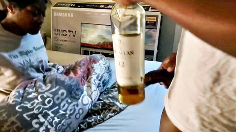 Black couple's intense blowjob scene with whisky bottle tease in bedroom