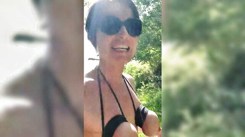 MILF Julie in black bikini outdoors, smiling with big tits exposed