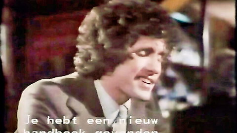 Vintage 1979 adult film thumbnail of suited man with mustache speaking