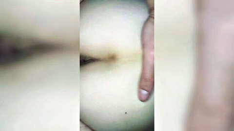 Closeup of woman's pale tight asshole with finger probing the puckered hole