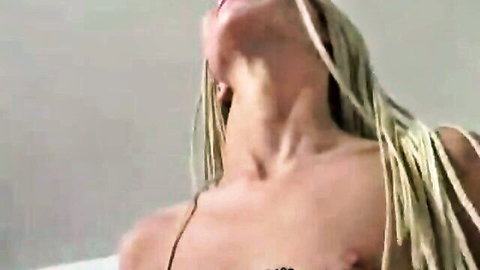 Blonde with braids arches neck back moaning passionately topless