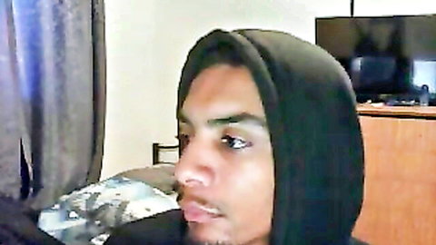 Young African guy in black hoodie, intense gaze on cam show