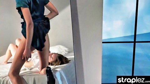 Dominant woman in dress fucks submissive girlfriend on bed intensely