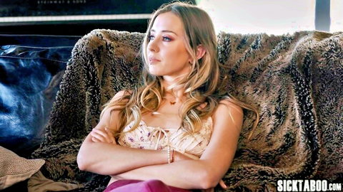 Blonde MILF with big ass, arms crossed in low-cut top and skirt