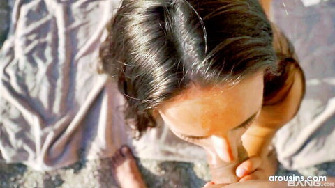 Betzz giving blowjob on sunny beach, dark hair woman in light top