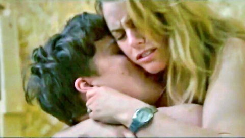 Blonde woman in passionate nude embrace and kiss with dark-haired man