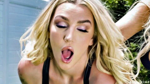 Kayley Gunner blonde with tongue out in hot lesbian BDSM scene