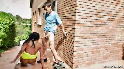 Ebony babe in yellow thong bent over doggy style outdoors fucked by white guy's big cock against brick wall
