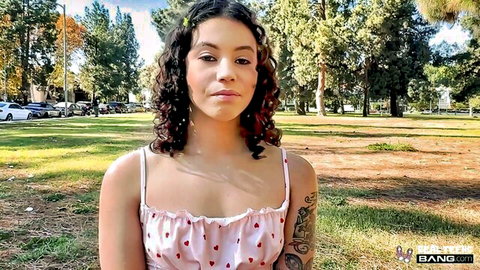 Cute teen Nico Luva in pink spaghetti strap dress outdoors in park