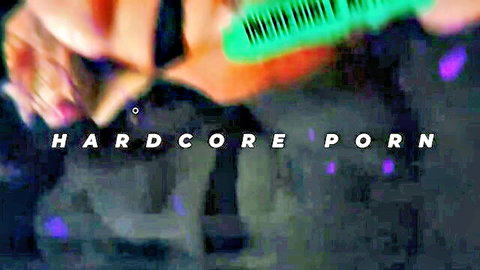 Hands gripping green comb with bold hardcore porn watermark overlay