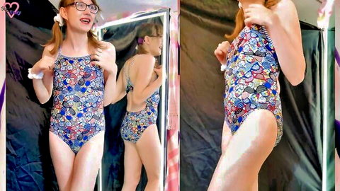 Cute trans redhead in floral swimsuit try-on mirror pose