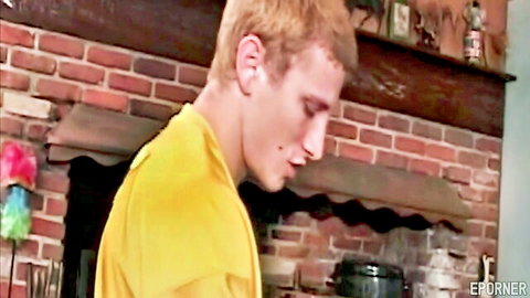 Young blonde guy in yellow shirt, side profile in rustic home, amateur feel