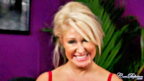 Tanned blonde MILF Mia smiling seductively in red top