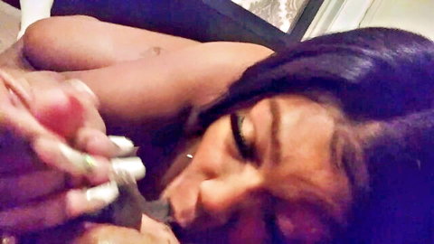 Ebony babe with big tits and pierced nipples licks huge black cock held by her manicured hand in POV