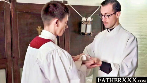 Two priests in forbidden gay hand touch in church vestments