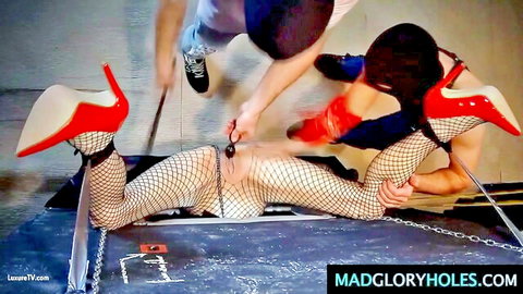 Bound woman in fishnets and red heels spreads legs exposing pussy in gloryhole bondage whipping