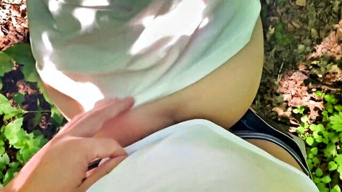 POV of hand fingering skinny girl's exposed pussy outdoors in forest