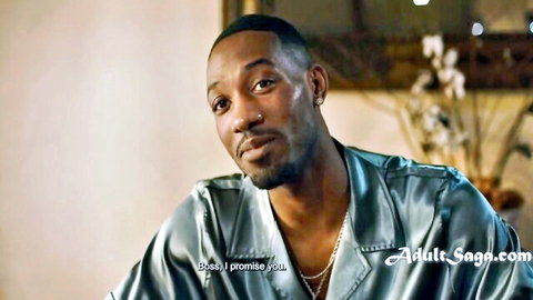 Isiah Maxwell in shiny jacket, intense gaze from Adult Time interracial scene