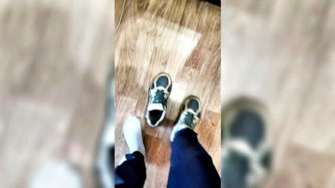 Woman's dirty gray sneakers and white socked foot on floor, foot fetish tease to sniff
