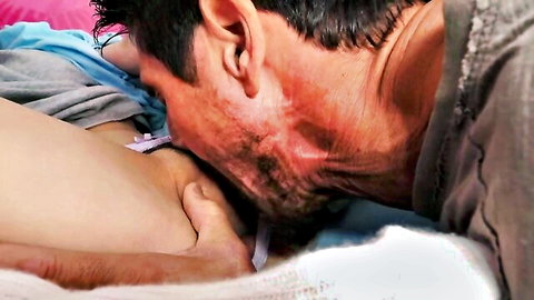 Bearded man passionately kissing woman's neck in intimate daddy lovers embrace