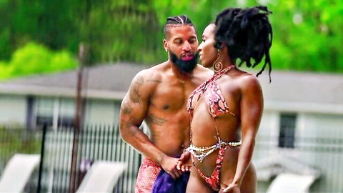 Pha Baby in skimpy bikini embraced by tattooed black man poolside