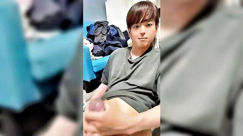 Young Japanese twink lifts gray shirt holding pink dildo to his crotch in solo tease