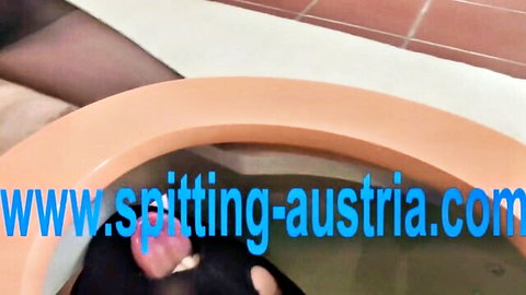 Femdom mistress in black stockings straddles orange toilet bowl humiliating slave in bathroom BDSM scene