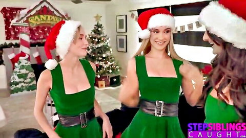Busty blondes and brunettes in sexy green elf costumes and Santa hats, playful Christmas pose