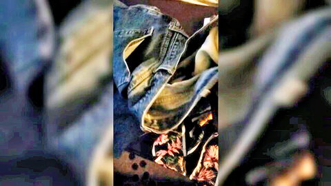 Discarded jeans and floral clothes on floor in thief watches wife sex toy scene