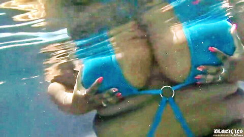 Busty babe squeezing huge wet tits in blue bikini top underwater