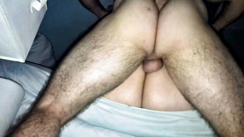 Hairy man spreads legs exposing cock and balls in closeup view