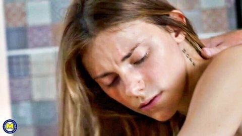 Topless young blonde woman eyes closed in ecstasy as hand massages her neck