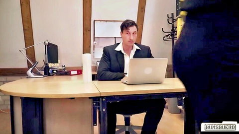 Inked hot MILF in black dress with suited man at office desk