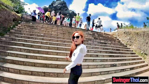 Sexy redhead Thai tourist posing on Bali steps in casual outfit