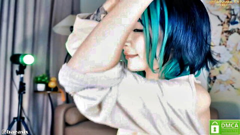 Bae Asian camshow tease in off-shoulder sweater, teal blue hair, seductive pose