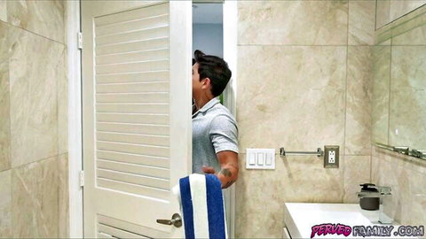 Muscular stepbrother peeking through open bathroom door holding towel spying on stepsister