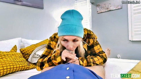 Blonde in blue beanie and plaid shirt deepthroats thick cock on bed