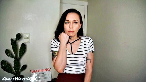 Tattooed MILF teases with deep cleavage in striped top choker and red skirt