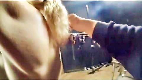 Blonde woman with large breasts whipped by bearded muscular man in BDSM scene