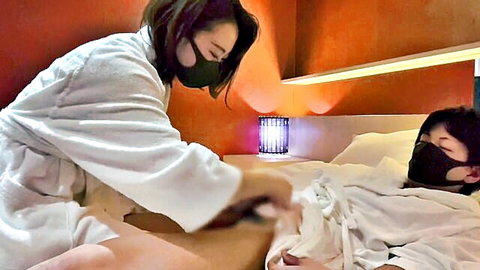 Japanese amateur couple in robes and masks, woman teasing man's thigh intimately