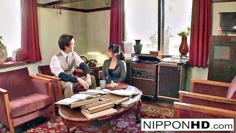 Petite Japanese secretary with glasses talks intimately with boss in vintage office