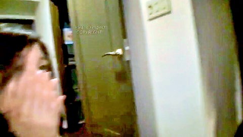Shy Japanese wife peeking coyly from behind hand in amateur bedroom tease