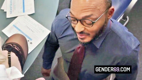 Trans boss in stockings under desk with suited BBC executive